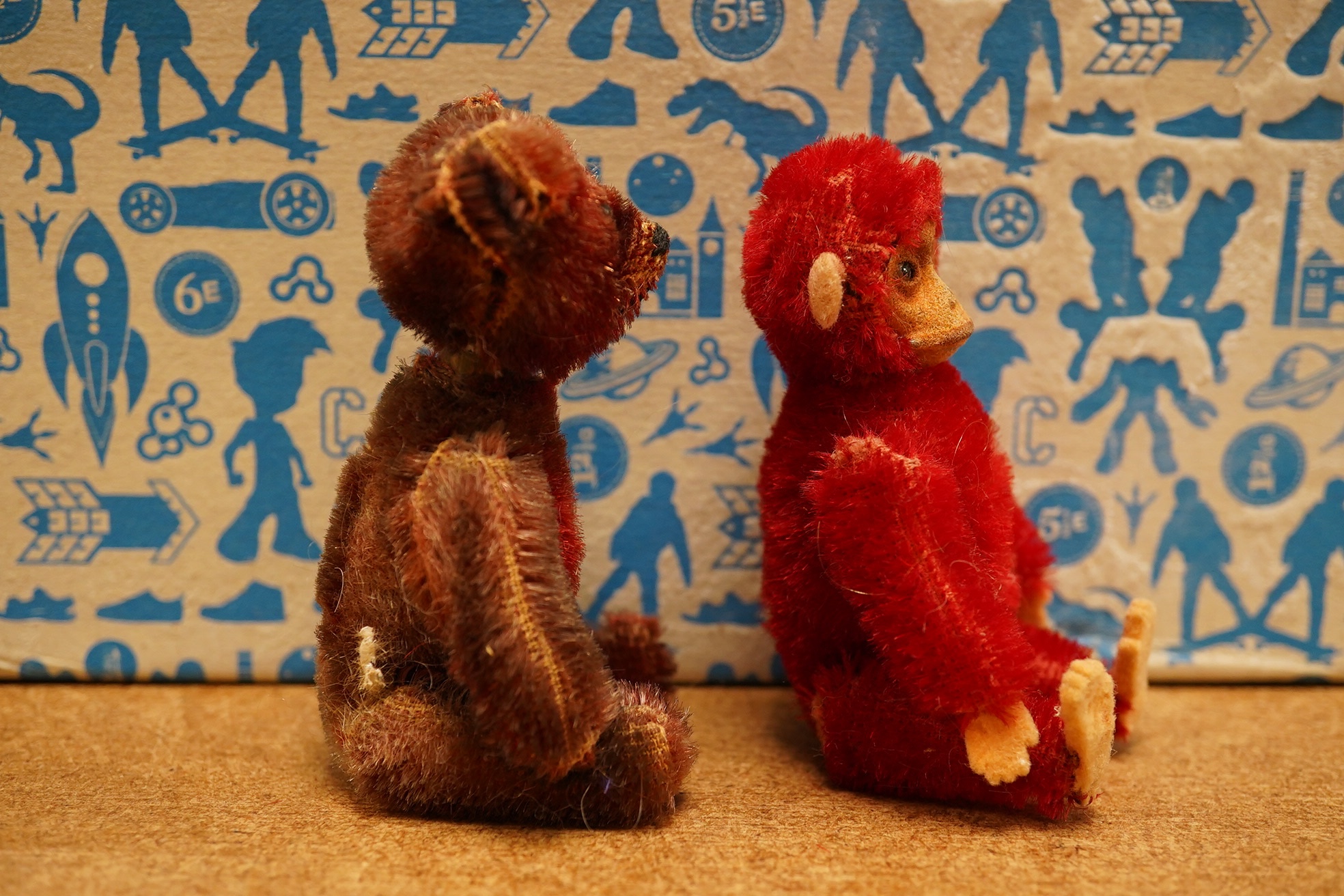 A red Schuco monkey compact with some slight wear to back of legs, otherwise in good unfaded condition, c1920, height 9cm, together with a Schuco Teddy manicure set in good condition, red mohair faded, height 9cm, c.1920